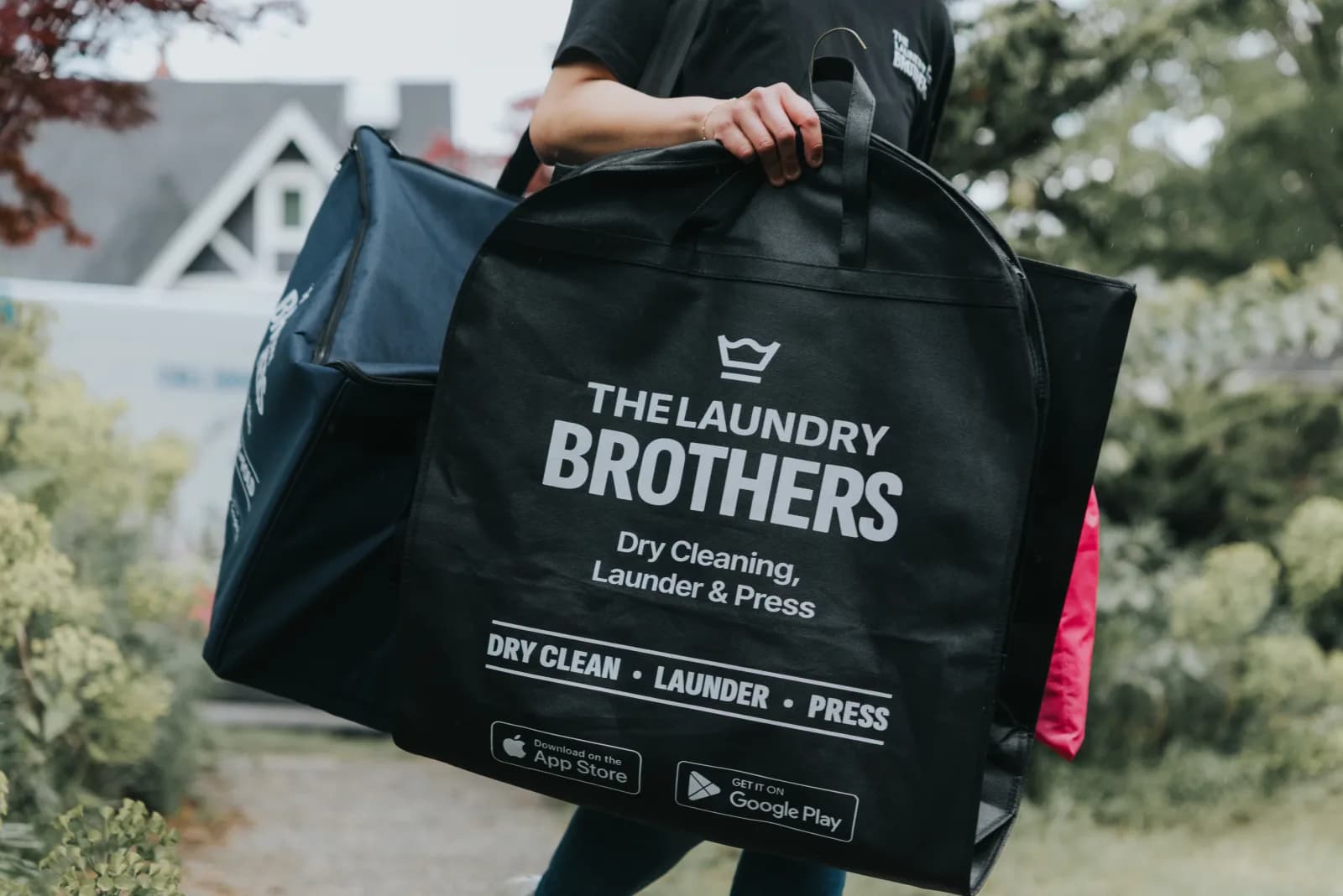 A Laundry Brothers driver delivering clean folded laundry at a Vancouver home.
